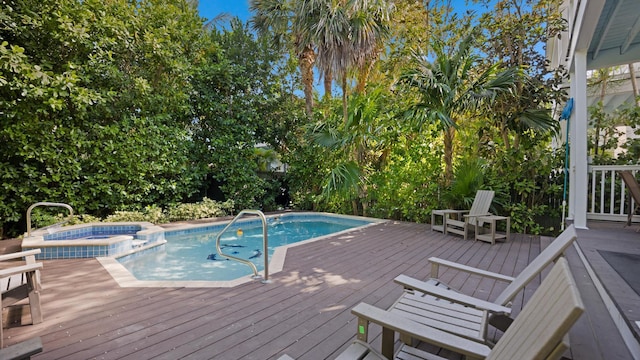 view of pool with an in ground hot tub and a deck