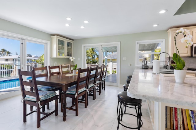 dining area featuring french doors and a healthy amount of sunlight