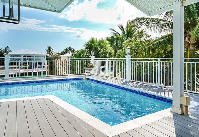 view of swimming pool featuring a gazebo and a deck