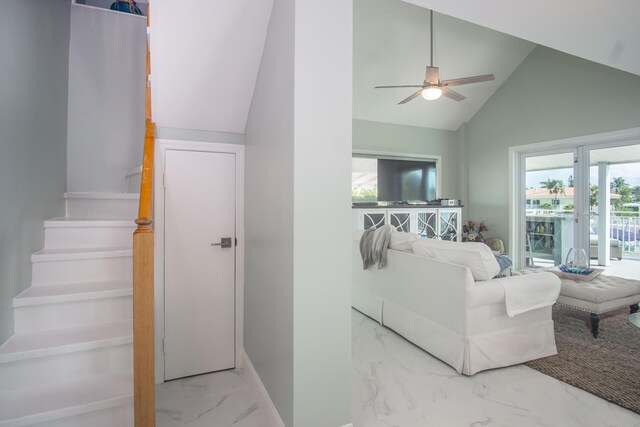 living room featuring ceiling fan and lofted ceiling