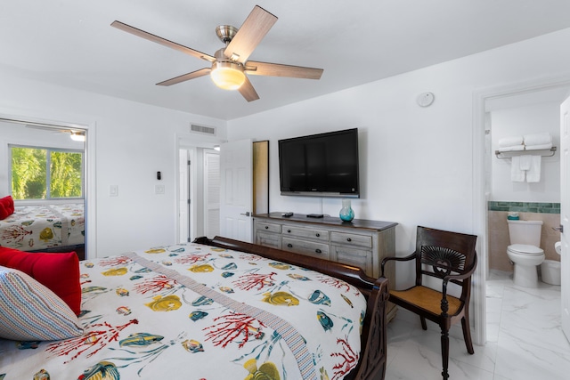 bedroom featuring connected bathroom, ceiling fan, and tile walls