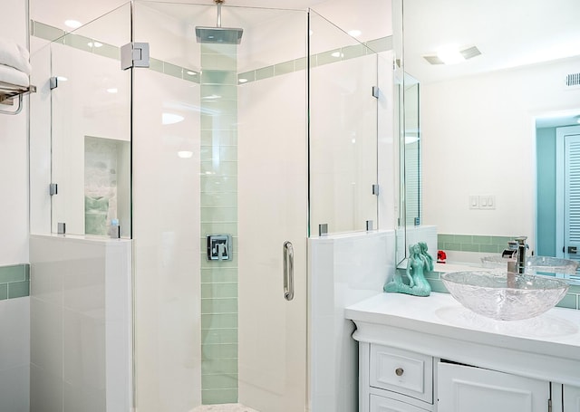 bathroom with vanity and a shower with shower door