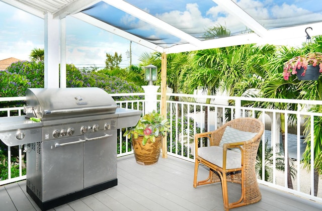 deck with a grill and a pergola