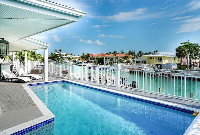 view of pool featuring a water view and a patio area