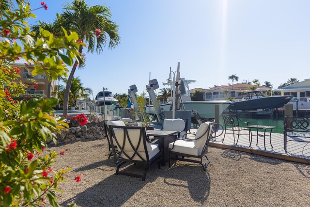 view of patio featuring a water view and a boat dock