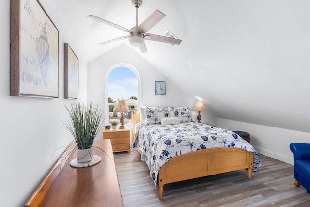 bedroom featuring wood-type flooring, ceiling fan, and vaulted ceiling