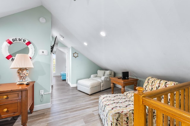 bedroom featuring vaulted ceiling and light wood-type flooring