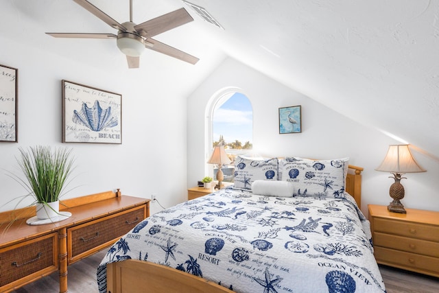 bedroom with wood-type flooring, vaulted ceiling, and ceiling fan