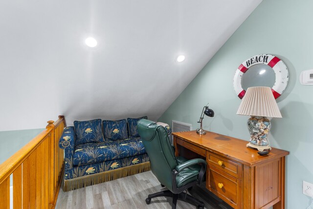 office with wood-type flooring and vaulted ceiling