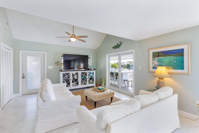 living room featuring ceiling fan and vaulted ceiling