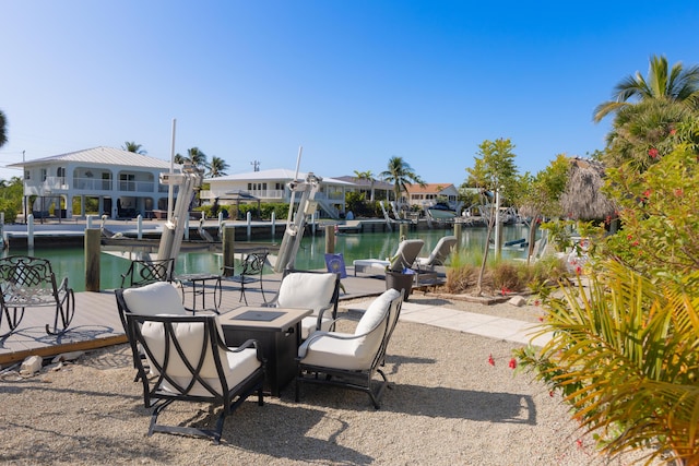 view of patio featuring a water view and a dock