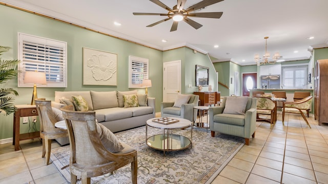 tiled living room featuring crown molding and ceiling fan with notable chandelier