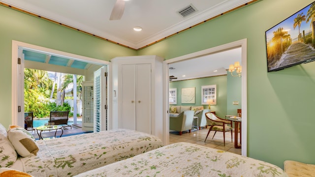 tiled bedroom with ceiling fan, ornamental molding, and access to exterior