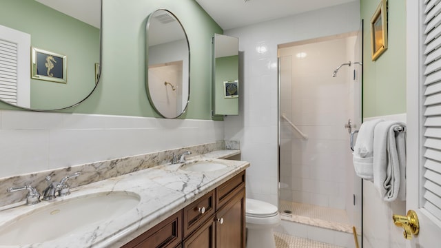 bathroom with vanity, a tile shower, and toilet