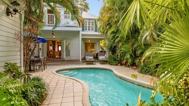 view of pool with ceiling fan and a patio area