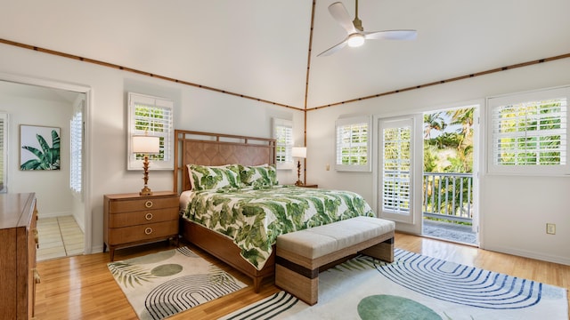 bedroom featuring a towering ceiling, access to outside, light hardwood / wood-style floors, and ceiling fan