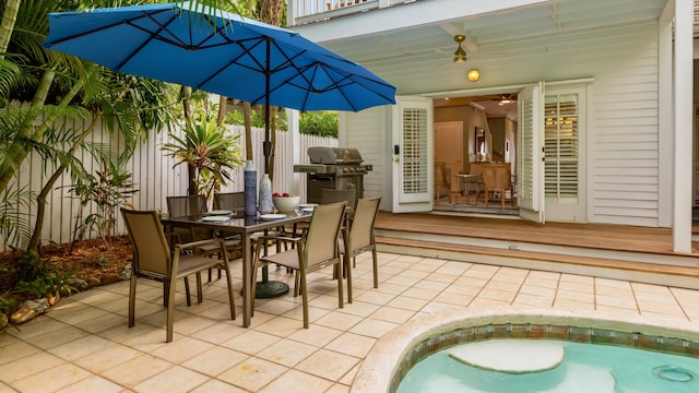 view of patio with a pool side deck and grilling area