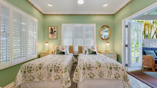 bedroom featuring multiple windows, access to outside, and ornamental molding