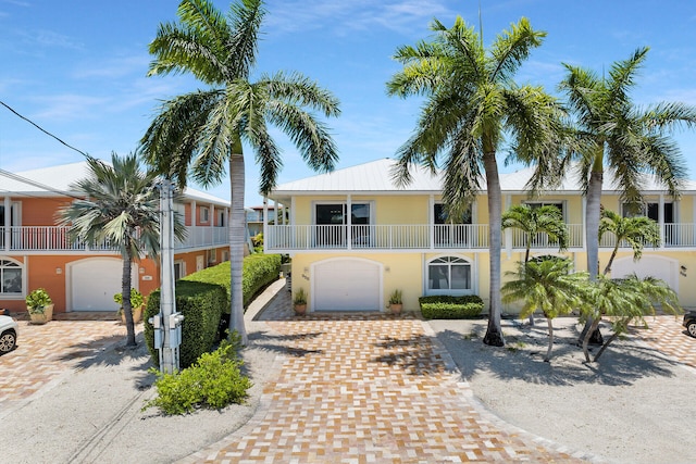 view of front of home with a garage and a balcony