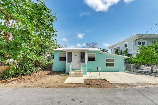 462 Sunset Dr, Key Largo, FL 33037 - bungalow-style house featuring fence, stucco siding, and metal roof