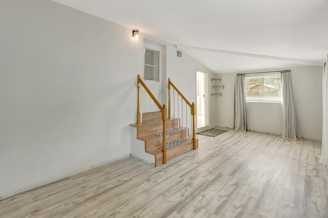 462 Sunset Dr, Key Largo, FL 33037 - unfurnished living room with light wood-type flooring, vaulted ceiling, and stairway