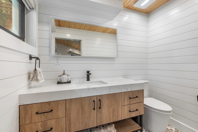 1511 S Street, Key West, FL 33040 - half bathroom featuring vanity, wooden walls, toilet, and wood ceiling