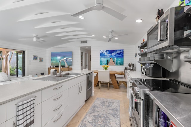 1511 S Street, Key West, FL 33040 - kitchen with stainless steel appliances, a ceiling fan, lofted ceiling, white cabinets, and light countertops