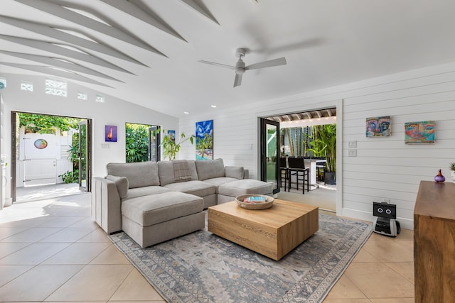 1511 S Street, Key West, FL 33040 - living room with light tile patterned floors, vaulted ceiling, a ceiling fan, and wood walls
