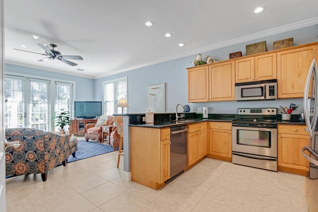 144 Anglers Way, Islamorada, FL 33036 - kitchen featuring stainless steel appliances, light brown cabinetry, a peninsula, ornamental molding, and a sink