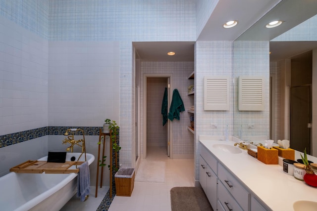 81250 Overseas Hwy Unit 2, Islamorada, FL 33036 - full bath with double vanity, a soaking tub, tile patterned flooring, recessed lighting, and wallpapered walls