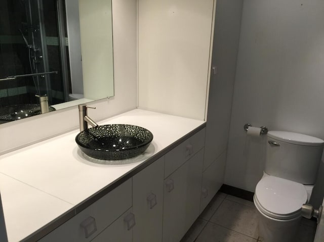 bathroom with tile patterned floors, toilet, and vanity