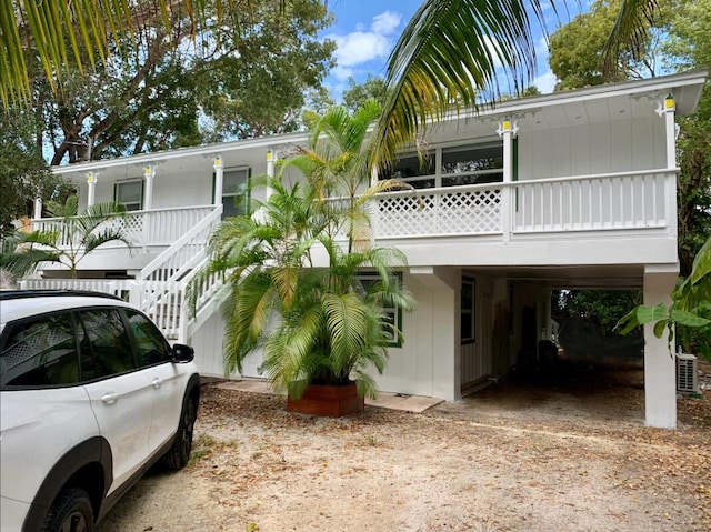 view of front of property with central AC unit and a carport