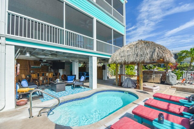 view of swimming pool with a fire pit, a gazebo, exterior bar, and a patio area