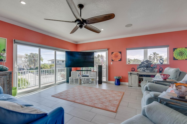 living room featuring crown molding, a textured ceiling, and ceiling fan