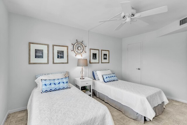 bedroom featuring light carpet and ceiling fan