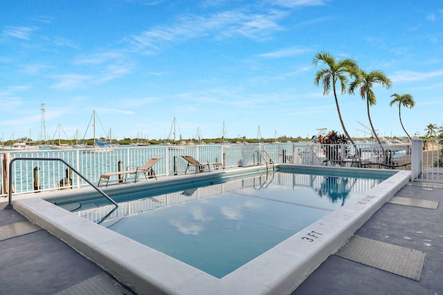 view of swimming pool with a water view