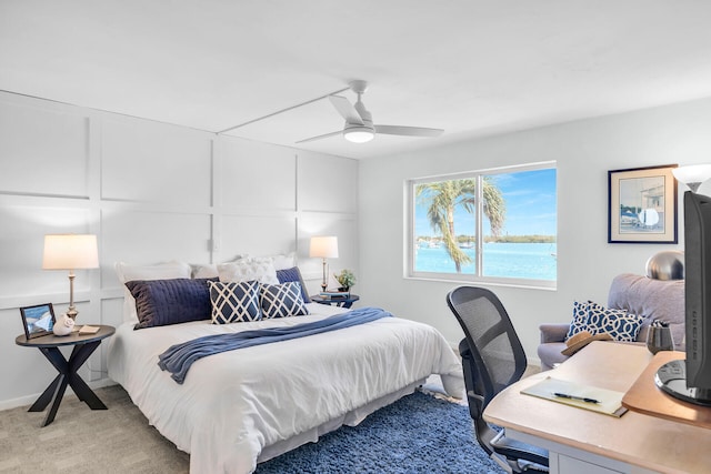 bedroom featuring light colored carpet and ceiling fan