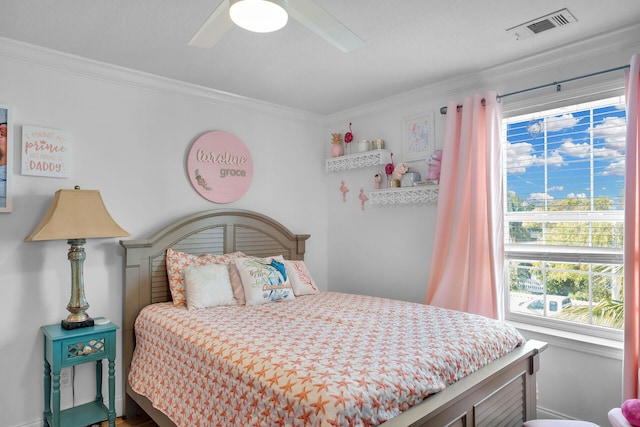 bedroom with ornamental molding and ceiling fan