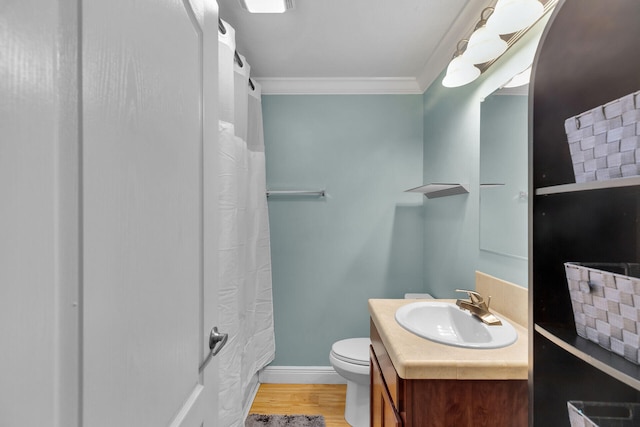 bathroom with a shower with shower curtain, vanity, wood-type flooring, ornamental molding, and toilet