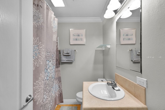 bathroom with crown molding, hardwood / wood-style floors, vanity, and toilet