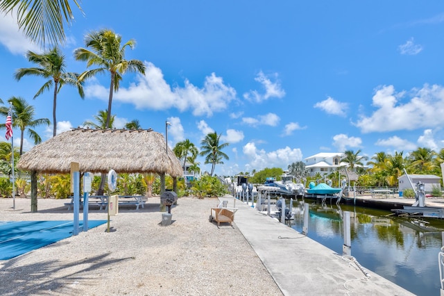 view of dock with a gazebo and a water view