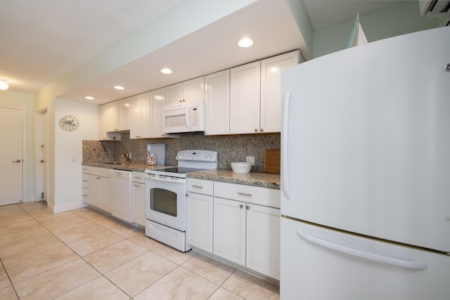 kitchen featuring white appliances, light tile patterned floors, decorative backsplash, and white cabinets