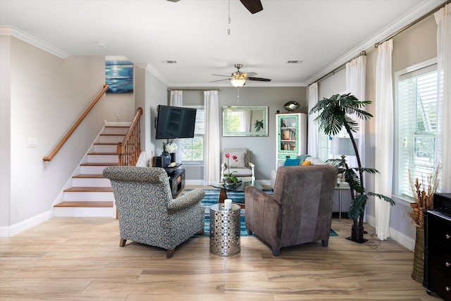 living room featuring crown molding, ceiling fan, and light hardwood / wood-style floors