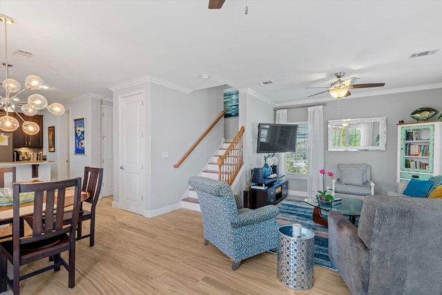 living room with crown molding, ceiling fan with notable chandelier, and light hardwood / wood-style floors