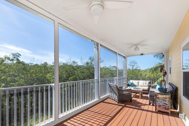 sunroom featuring ceiling fan