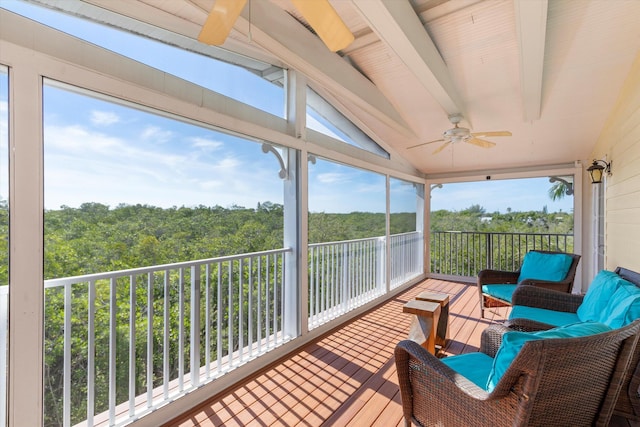 sunroom with vaulted ceiling with beams, plenty of natural light, and ceiling fan