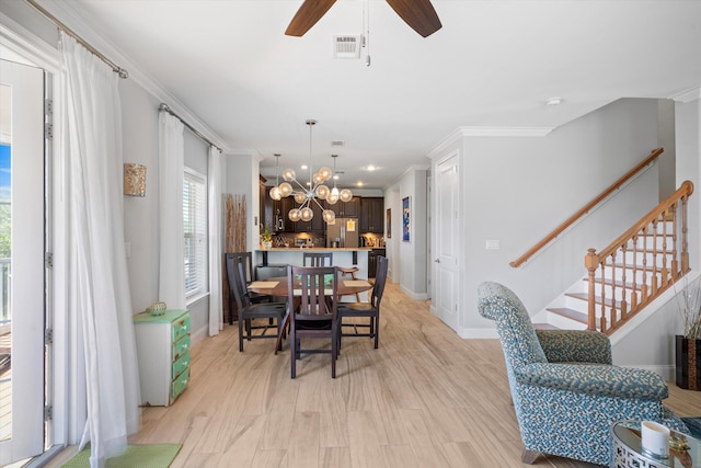 dining room with ornamental molding, ceiling fan with notable chandelier, and light wood-type flooring