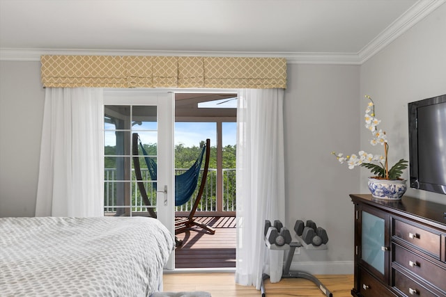 bedroom featuring access to exterior, crown molding, and light wood-type flooring