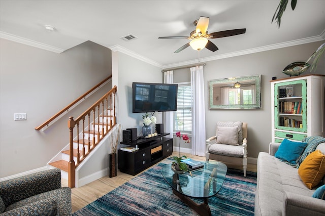 living room featuring crown molding, ceiling fan, and light hardwood / wood-style floors