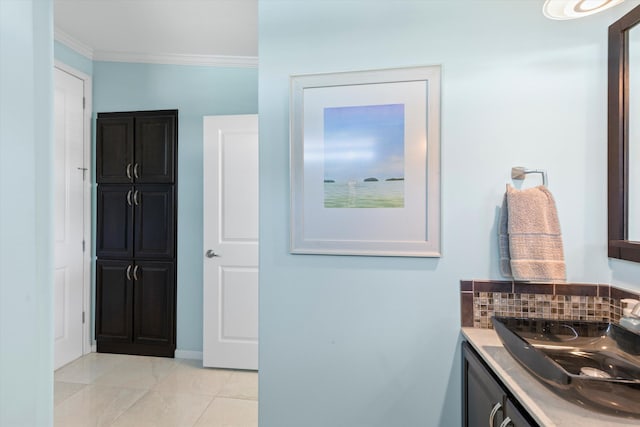 bathroom featuring crown molding, tile patterned floors, vanity, and tasteful backsplash